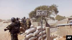 FILE - Cameroonian soldiers stand guard at a lookout post as they take part in operations against Boko Haram militants on Elbeid bridge that separates northern Cameroon form Nigeria's Borno state near the village of Fotokol, Cameroon, Feb. 25, 2015.