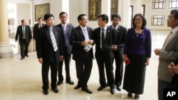 FILE PHOTO - Cambodia's opposition Cambodia National Rescue Party (CNRP) lawmaker members talk during a lunch break inside the National Assembly in Phnom Penh, Cambodia, Tuesday, Nov. 22, 2016. Cambodia's opposition party ended a six-month boycott of the parliament Tuesday, saying it wants to ensure that the national budget for 2017 is debated properly in the house. (AP Photo/Heng Sinith)