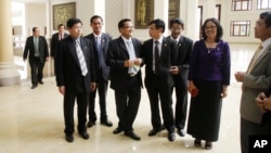 Cambodia's opposition Cambodia National Rescue Party (CNRP) lawmaker members talk during a lunch break inside the National Assembly in Phnom Penh, Cambodia, Tuesday, Nov. 22, 2016. Cambodia's opposition party ended a six-month boycott of the parliament Tu