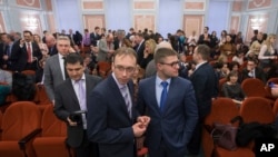 FILE - Jehovah's Witnesses wait in a courtroom in Moscow, Russia, April 20, 2017. On Monday, Russia's Supreme Court has banned the religious group from operating in the country.