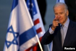 U.S. Vice President Joe Biden gestures after disembarking from a plane upon landing at Ben Gurion International Airport in Lod, near Tel Aviv, Israel, March 8, 2016.