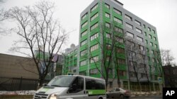 FILE - In this file photo taken Oct. 27, 2017, a car of Russian state-owned television station RT passes by the company's office in Moscow. 