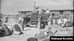 Belongings of Japanese-American internees newly arrived at the Minidoka camp from western Washington state await delivery to their barracks in August 1942 (Francis Stewart, War Relocation Authority via National Archives). Hawaii Attorney General Douglas Chin likens the Tump administration's travel ban to the World War II-era wholesale internment of Japanese Americans, German Americans and Italian Americans because of national security concerns.