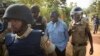 Uganda's main opposition leader Kizza Besigye, center, is arrested by police and thrown into the back of a blacked-out police van which whisked him away and was later seen at a rural police station, outside his home in Kasangati, Uganda Monday, Feb. 22, 2016.