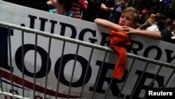 A child watches the results come in at Republican U.S. Senate candidate Roy Moore's election night party in Montgomery, Alabama, Dec. 12, 2017. Moore has refused to concede the election.