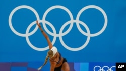 Germany's Margareta Kozuch stretches during a Beach Volleyball training session ahead of the 2020 Summer Olympics, July 20, 2021, in Tokyo.