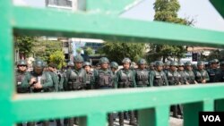 រូបឯកសារ៖ កង​កម្លាំង​ប៉ូលិស​និង​កងកម្លាំង​សន្តិសុខ​រាជធានី​ភ្នំពេញ​ឈរ​បាំង​ក្រុម​សហជីព​និង​ក្រុម​អង្គការ​សង្គម​ស៊ីវិល មិន​ឲ្យ​ចេញ​ដើរ​ក្បួនដាក់​ញត្តិស្តី​ពី «តម្រូវ​ការ​អាទិភាព​របស់​ស្រ្តី»នៅ​ក្នុង​ពហុកីឡដ្ឋាន​ជាតិ​អូឡាំពិក កាលពី​ថ្ងៃ០៨ ខែមីនា ឆ្នាំ២០១៩។ (ទុំ ម្លិះ/VOA)