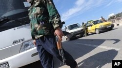 A militant with the Free Syrian Army walks in the northwestern city of Idlib, February 21, 2012.