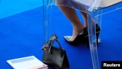 The handbag of Brigitte Macron, wife of French President Emmanuel Macron, is seen as she attends the traditional Bastille Day military parade on the Champs-Elysees Avenue in Paris, July 14, 2018. 