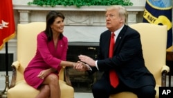 FILE - President Donald Trump meets with outgoing U.S. Ambassador to the United Nations Nikki Haley in the Oval Office of the White House, Oct. 9, 2018, in Washington.