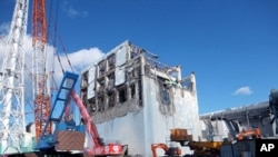 The crippled Fukushima Daiichi nuclear power plant's No.4 reactor building is seen after the removal of debris on the upper side of the unit in Fukushima prefecture, January 5, 2012.