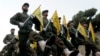 FILE - Hezbollah fighters parade in a southern suburb of Beirut, Lebanon, Nov. 12, 2010.