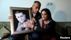 The mother and father of Muhammad Musallam, an Israeli Arab held by Islamic State in Syria as an alleged spy, react with a picture of him in their East Jerusalem home, March 10, 2015. 