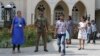 A Sri Lankan government soldier secures the premises of a Catholic church as devotees leave after Sunday Mass in Colombo, Sri Lanka, May 12, 2019.