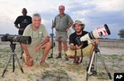 Photographer Brent Stapelkamp is seen with colleagues at the Hwange National Park in this 2014 photo. Stapelkamp, a lion researcher and part of a team that had tracked and studied Cecil the lion for nine years, darted him and attached a collar last year.