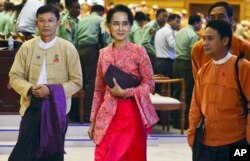 FILE - Myanmar opposition leader Aung San Suu Kyi walks along with other lawmakers of her National League for Democracy party. The NLD won an overwhelming majority of seats in both houses of parliament in last November's election.