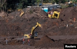 Members of a rescue team search for victims of a collapsed tailings dam owned by Brazilian mining company Vale SA, in Brumadinho, Brazil, Feb. 10, 2019.