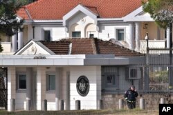 A police officer stands guard outside the U.S. embassy in Montenegro's capital Podgorica, Feb. 22, 2018.