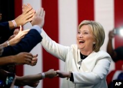 Democratic presidential candidate Hillary Clinton reacts to supporters as she arrives to address supporters at her Super Tuesday election night rally in Miami, Tuesday, March 1, 2016. (AP Photo/Gerald Herbert)