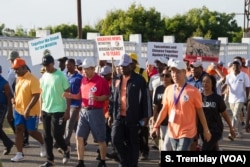Chinese Ambassador to Tanzania Lu Youqing walks with Tanzanian officials, celebrities and conservationists during the ‘Walk for Elephants’ march in Dar es Salaam.
