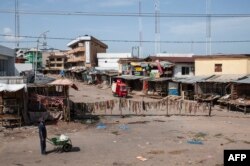 FILE - A man walks through an empty market in Old Market Road in Onitsha on May 30, 2017, during a shutdown in commemoration of the 50th anniversary of the Nigerian Civil War.