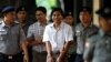 FILE - Police escort detained Reuters journalists Kyaw Soe Oo and Wa Lone as they arrive before a court hearing in Yangon, Myanmar, Aug. 20, 2018.