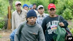 FILE PHOTO - Montagnards emerge from the forest after having fled from neighboring Vietnam in Korng village, Ratanakiri province, northeastern Cambodia, 10 kilometers (6.3 miles) from the Vietnamese border, in this Thursday, July 22, 2004 file photo. 