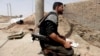 A Free Syrian Army fighter holds his weapon in Raqqa province, east Syria, May 6, 2013. 