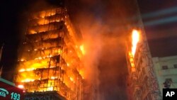 In this photo released by Sao Paulo Fire Department, a building on fire is seen in Sao Paulo, Brazil, May 1, 2018. (Sao Paulo Fire Department via AP)