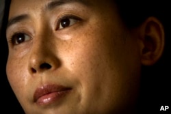 China Lawyers Crackdown: In this Wednesday, July 6, 2016 photo, Yuan Shanshan, the wife of detained Chinese lawyer Xie Yanyi, pauses during an interview in their apartment in Miyun, on the outskirts of Beijing.