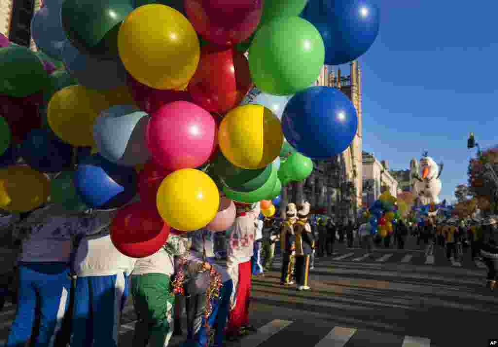 Participants take their place along the parade route before the Macy's Thanksgiving Day Parade begins in New York, Nov. 23, 2017.