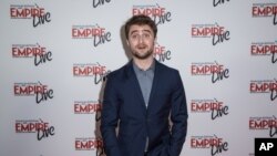 FILE - Daniel Radcliffe poses for photographers at the Empire Live event, in London, Sept. 23, 2016.