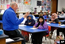 Mike McGraw teaches a biology class at Lewiston High School in Lewiston, Maine, Jan. 26, 2016. He is also the coach of the varsity soccer team whose undefeated team featured players from Somalia, Kenya and Congo.