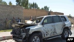 Afghan security forces inspect the site of a car bomb attack that targeted Laghman provincial governors convoy, in Mihtarlam, Laghman Province, Oct. 5, 2020.