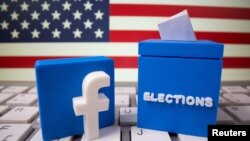FILE PHOTO: A 3D-printed elections box and Facebook logo are placed on a keyboard in front of U.S. flag in this illustration taken Oct. 6, 2020. 