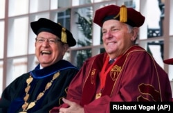 President of the University of Southern California C.L. Max Nikias, left, laughs with head of USC Board of Trsstees John Mork, during USC's 134th graduation ceremony in Los Angeles on Friday, May 12, 2017.