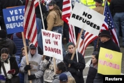 FILE - People gather to protest against the United States' acceptance of Syrian refugees in Olympia, Washington, Nov. 20, 2015.