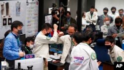Project members celebrate success of a trajectory control maneuver at JAXA's Sagamihara Campus, Japan, Dec. 5, 2020. Hayabusa2 successfully released a small capsule Dec. 5 and sent it toward Earth to deliver samples from a distant asteroid.
