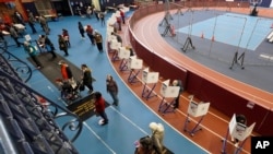 Voters mark their ballots during early voting at the Park Slope Armory YMCA, Oct. 27, 2020, in the Brooklyn borough of New York.