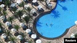 People are seen in a swimming pool at the Atlantis, The Palm Hotel, as the Emirates reopen to tourism amid the coronavirus pandemic, in Dubai, United Arab Emirates, July 7, 2020.