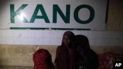 A passenger waits for an Ooni of Ife train to arrive in Kano, Nigeria.