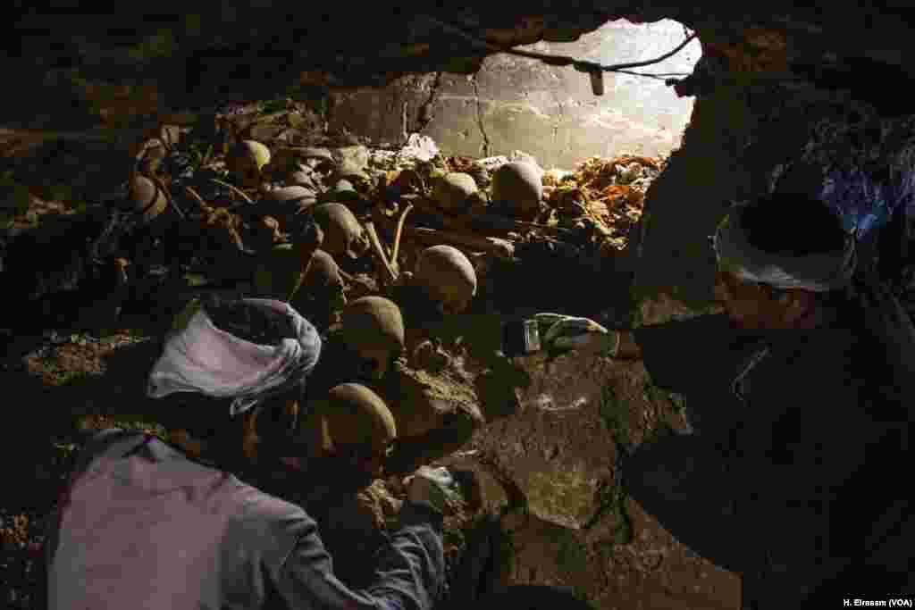 Two Egyptian archaeological workers excavate at (KAMPP 390) in Luxor, Egypt, Sept. 9, 2017. 