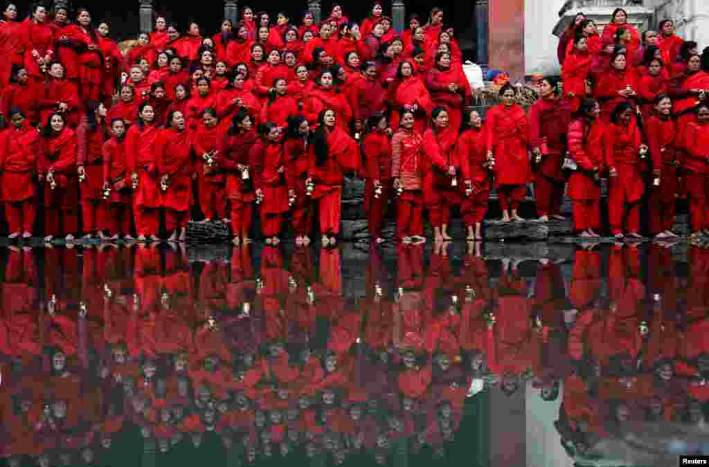 Devotees holding water pots wait to fill water from the polluted Bagmati River, which they consider to be holy, during the Swasthani Brata Katha festival at Pashupatinath Temple in Kathmandu, Nepal, Jan. 29, 2025. 