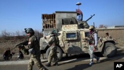 FILE - Security personnel arrive near the site of a suicide bombing near the Bagram Air Base in Parwan province of Kabul, Afghanistan, Dec. 11, 2019. The Bagram Air Base is the main American base north of the capital Kabul, the U.S. military said.
