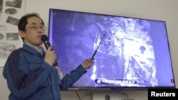 A Tokyo Electric Power Co. worker explains the operation in the No.3 reactor building at Fukushima Daiichi nuclear power plant in Okuma town, Fukushima prefecture, Japan, in this photo taken by Kyodo April 15, 2019. (Kyodo via Reuters)