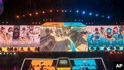 In this Friday, July 27, 2018 photo, fans watch the Philadelphia Fusion and London Spitfire compete in the Overwatch League Grand Finals' first night of competition at the Barclays Center in the Brooklyn borough of New York. (AP Photo/Terrin Waack)