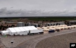 This undated photo provided by HHS’ Administration for Children and Families shows the shelter used to house unaccompanied foreign children in Tornillo, Texas.