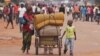 FILE - A family with their belongings on a makeshift trolley in the city of Bangui, Central African Republic, as clashes sectarian clashes erupted between rivaling Christian and Muslim militias, Sept. 30, 2015. 