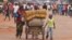 FILE - A family with their belongings on a makeshift trolley in the city of Bangui, Central African Republic, as clashes sectarian clashes erupted between rivaling Christian and Muslim militias, Sept. 30, 2015. 