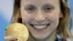 United States' Katie Ledecky shows off her gold medal in the women's 800-meter freestyle medals ceremony during the swimming competitions at the 2016 Summer Olympics, Friday, Aug. 12, 2016, in Rio de Janeiro, Brazil. 
